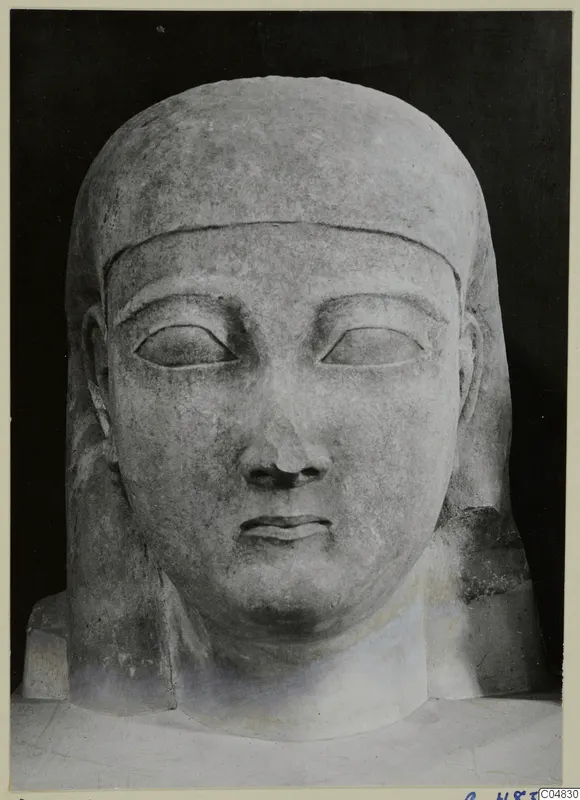 Limestone Cypro-Egyptian head and bust sculpture, facing forward against a black background