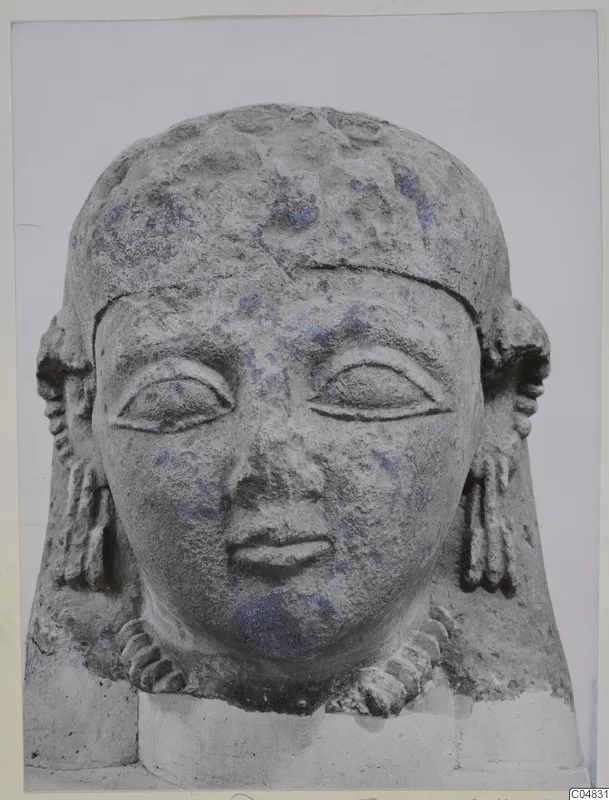 Limestone Neo-Cypriote head seen from the front, with carved eyes, nose and mouth and traces of blue paint