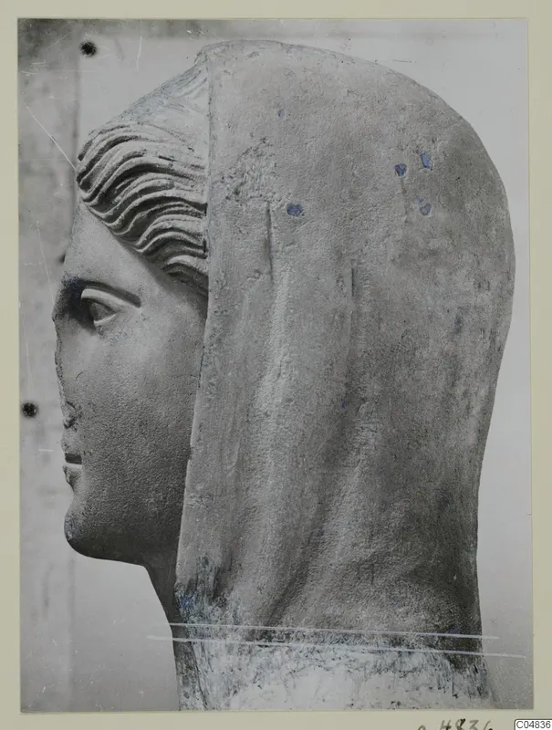 Stone statue head from Arsos, shown in profile facing left, with a veil or hood falling behind it.