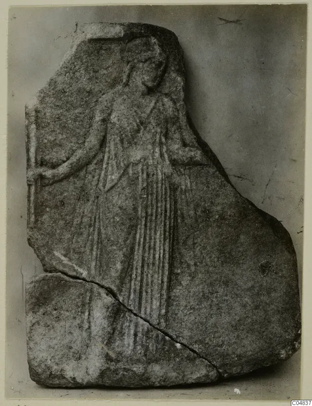 Marble relief fragment of a standing figure in long drapery, with a diagonal break across the lower left