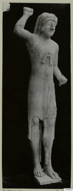 Limestone statue of a standing figure from Kition, one arm raised with a clenched fist