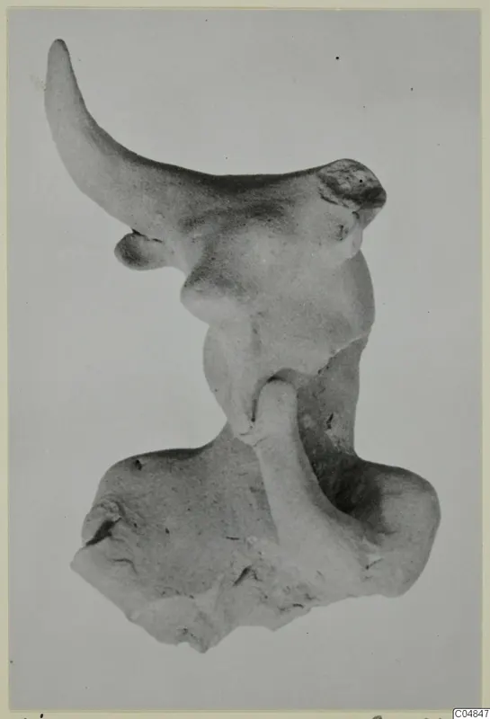 Terracotta figurine fragment from Ayia Irini, Minor Plastic 2, against a plain grey background