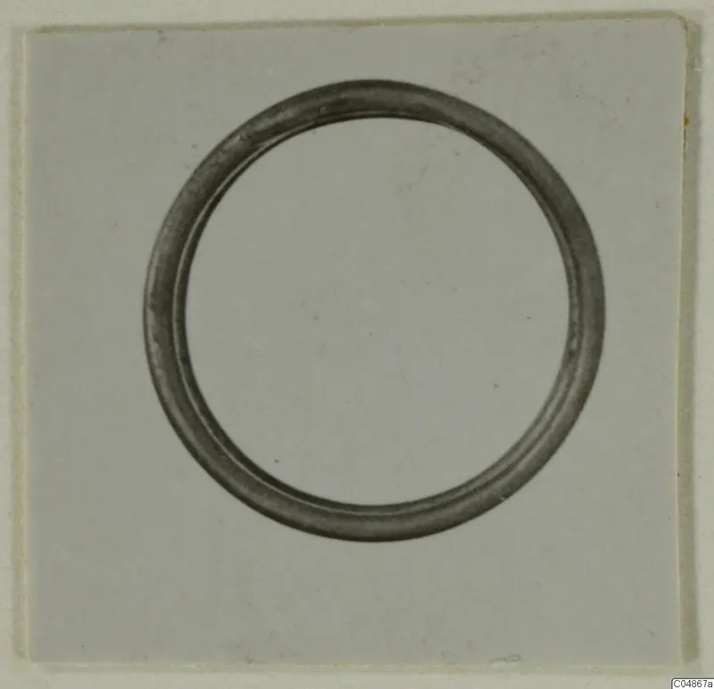 Hair-ring from Enkomi, a plain circular ring photographed on a light card.