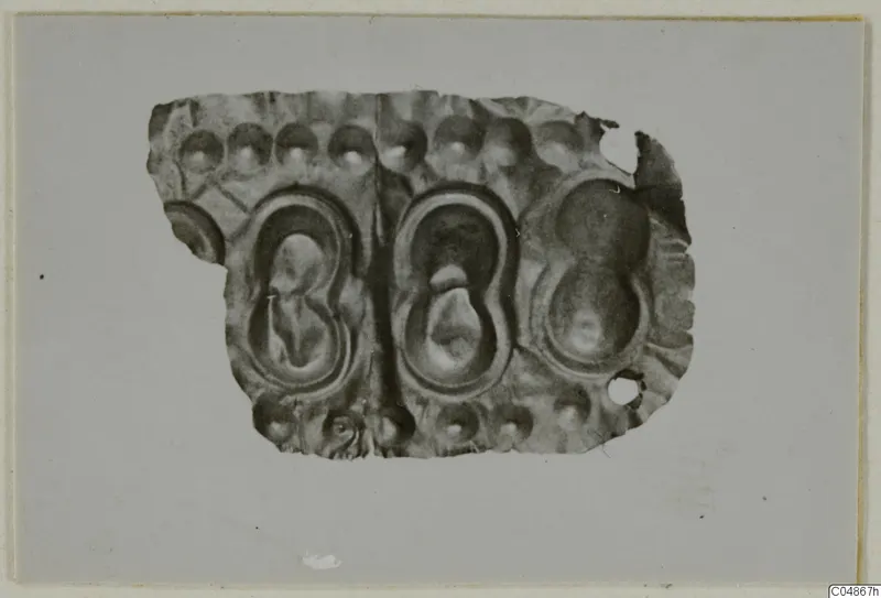 Embossed metal sheet fragment from Enkomi with two large oval panels and rows of round bosses