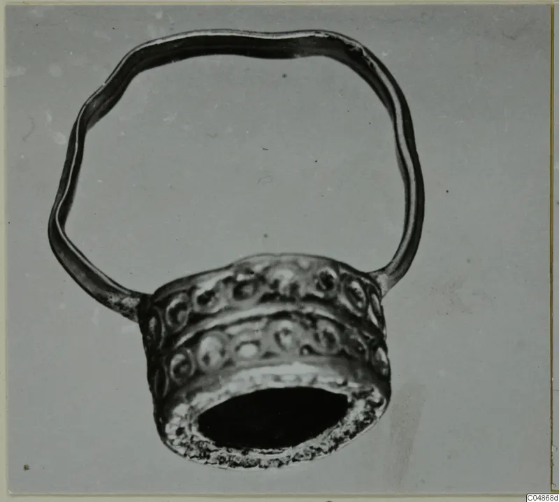 Finger ring from Enkomi with a wavy hoop and a wide bezel decorated with raised circular bosses