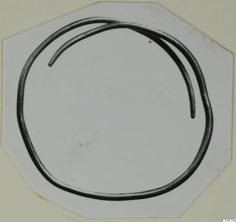 Bronze Age gold and silver bracelet: a thick, open loop of metal with overlapping ends.
