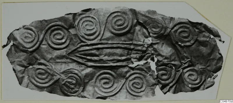 Thin metal sheet with embossed spiral pattern and three raised horizontal ridges across its centre