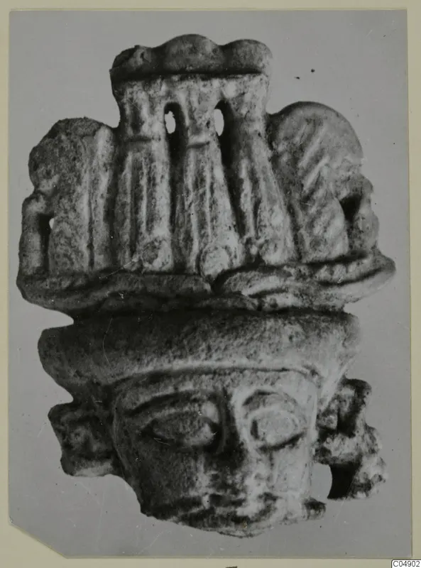 Small figurine with a broad face and tall headdress with two openings, from Amathus