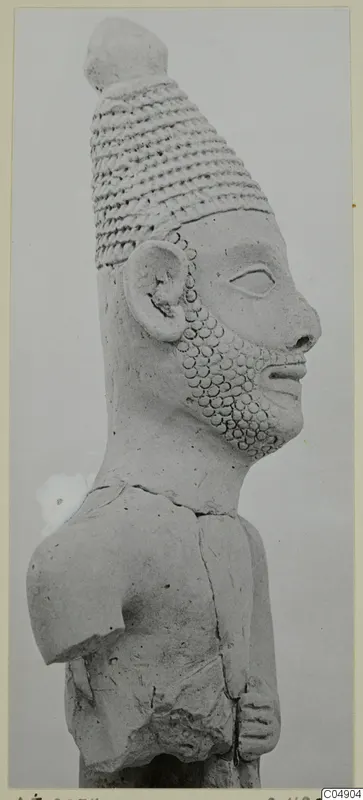Terracotta figurine from Ayia Irini, head and upper torso in profile, with a tall banded headdress and a dotted beard