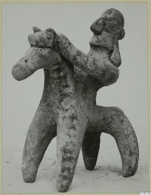 Terracotta figurine of a rider on a four-legged animal, shown against a pale background