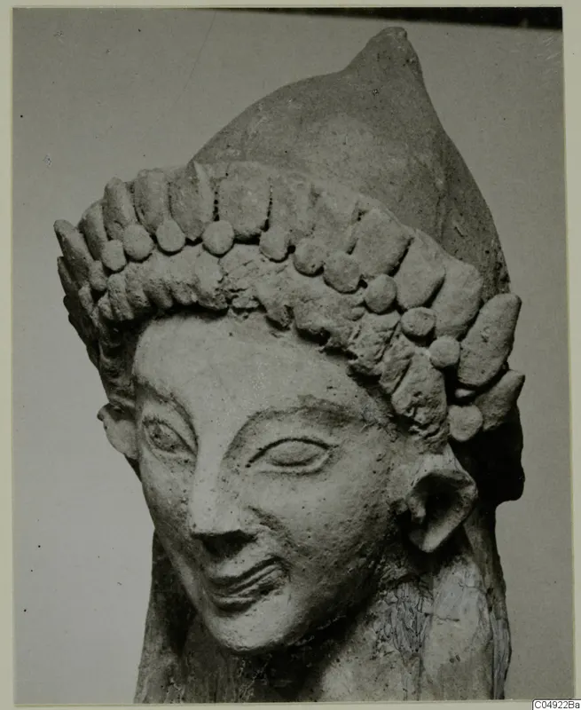 Sculpted head with a tall headdress of rounded knobs, from Mersinaki