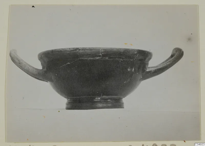 Black glazed pottery bowl with two horizontal handles, seen in side view, from Marion