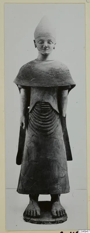 Terracotta Proto-Cypriote II statue of a standing figure with a short beard and a tall conical head covering