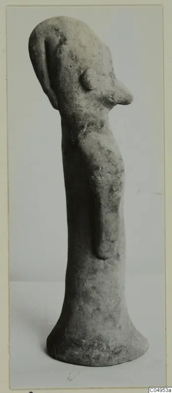 Terracotta figurine of a standing figure with a long, narrow body and a flared base, shown in three-quarter view