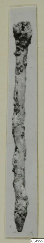 Long corroded metal object from Amathus, with a thicker rounded head tapering to a point.