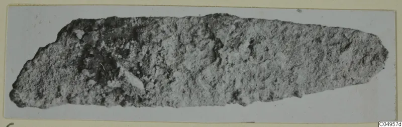 Corroded iron tool from Amathus, elongated and tapering toward one end.
