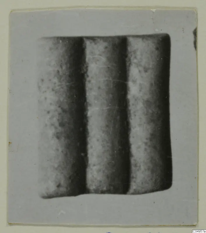 Three cylindrical objects set side by side, close view, from Amathus