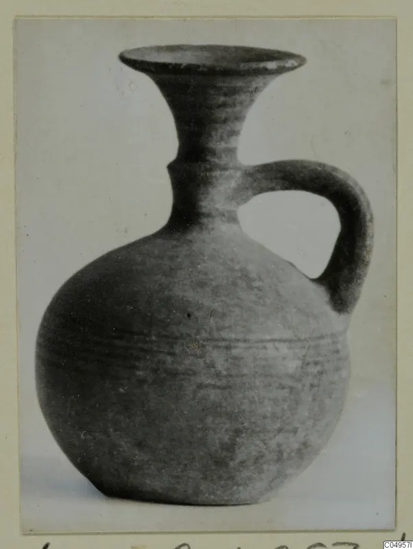 Handled vessel with a flaring neck from Amathus, photographed against a pale background
