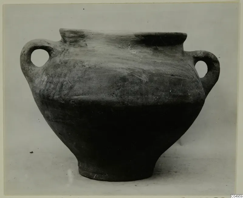 Two-handled wheel-made pottery vessel from Milia with a wide mouth and dark, plain surface