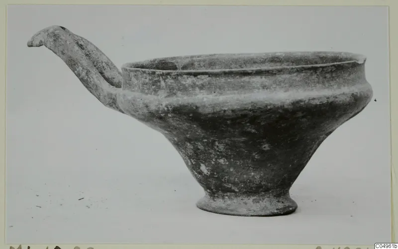 Pottery Base-Ring Ware bowl with a long strap handle and a tall ring foot, from Milia