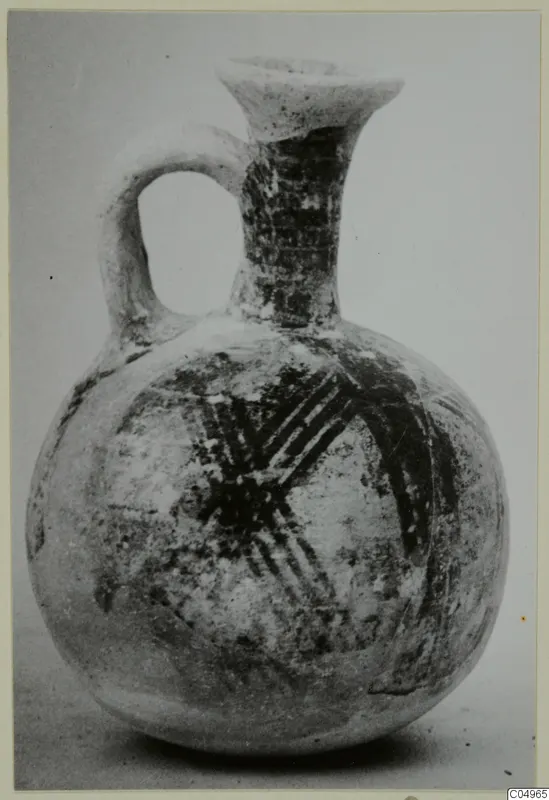 Pottery Bichrome Wheel-made jug with a loop handle and dark painted bands, from Milia