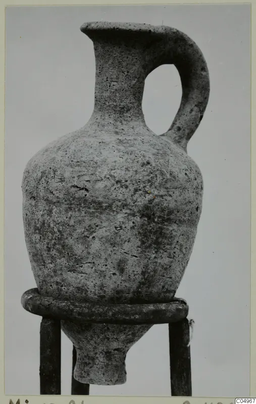 Pottery Plain White Wheel-made jug with a single loop handle, set on a ring stand
