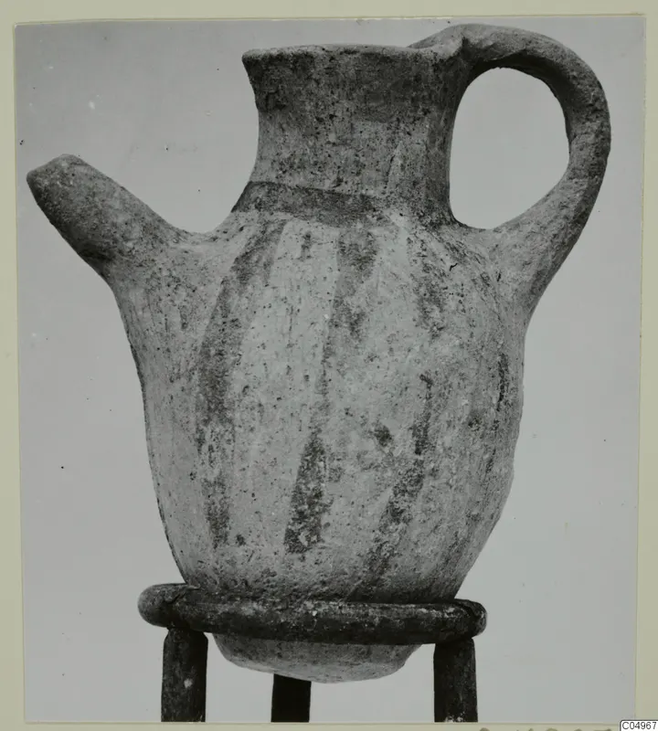 White Painted IV-V jug from Milia with a beak spout, strap handle and dark painted vertical stripes