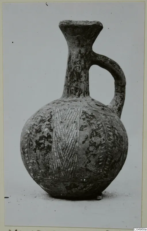 Pottery jug in Black Slip Ware with a single loop handle and banded decoration, from Milia