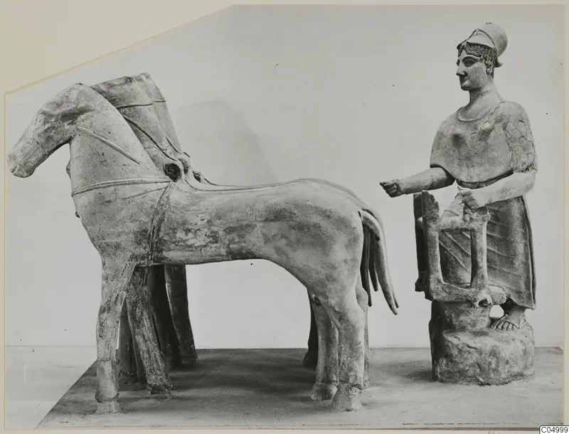 Terracotta group of a horse and a helmeted standing figure beside a rectangular frame, on a plain background.