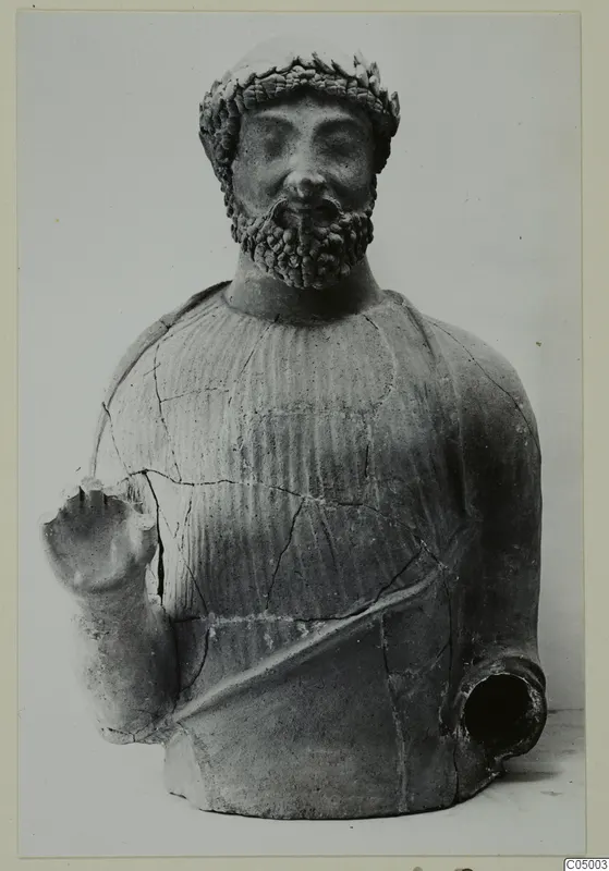 Terracotta bust of a bearded man with a leaf-like headband, one arm raised, and a spout at the lower right.