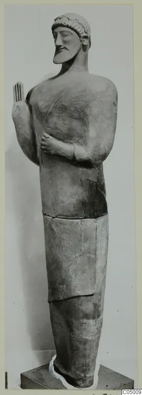 Statue of a standing bearded man with one hand raised, from Mersinaki.