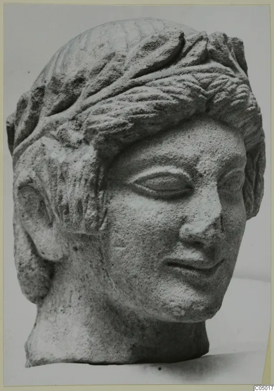 Limestone head sculpture from Mersinaki with layered hair and a slight smile