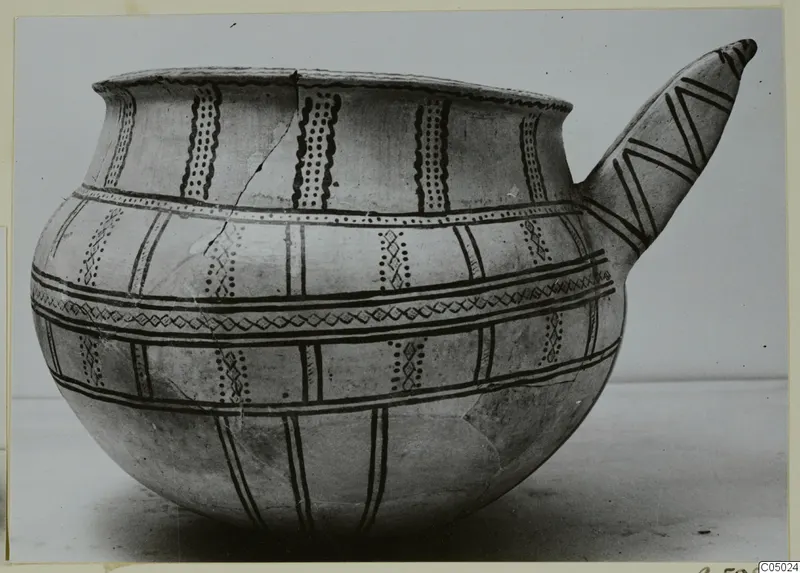 Pottery White Slip Ware vessel with a long spout, painted with dark bands, dotted panels and zigzags