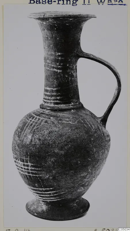 Base-Ring Ware jug with a flaring neck, single handle and ring base, decorated with pale painted lines