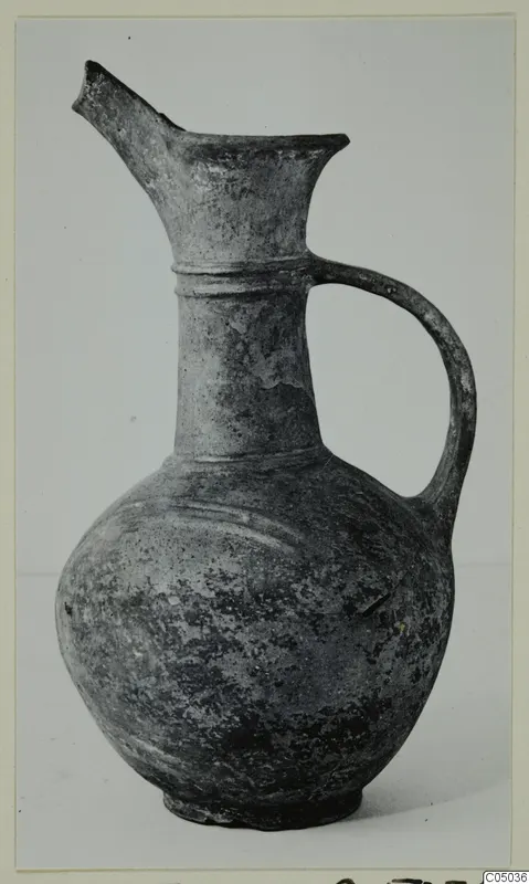 Pottery Base-Ring Ware jug with a single handle and a broken spout