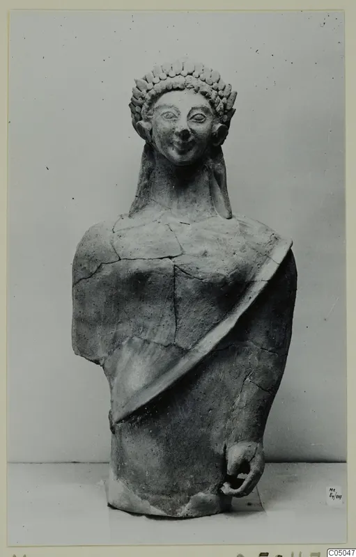 Terracotta bust of a figure with a band of raised curls around the head, from Mersinaki