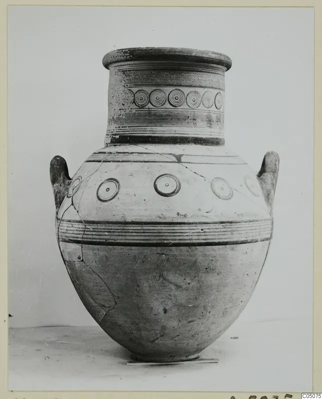 Pottery White Painted IV jar with two handles, a row of concentric circles on the neck and circles on the shoulder