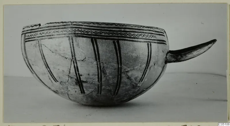Pottery White Slip Ware bowl with a curved handle and dark painted bands, from Enkomi
