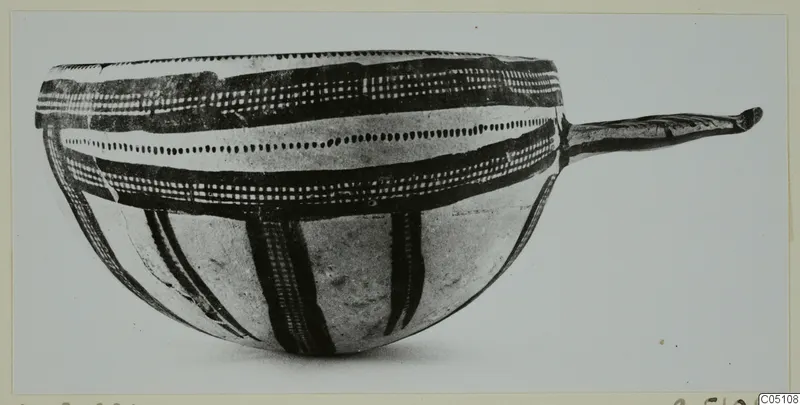 Bowl of White Slip Ware from Enkomi with dark painted bands and a long handle