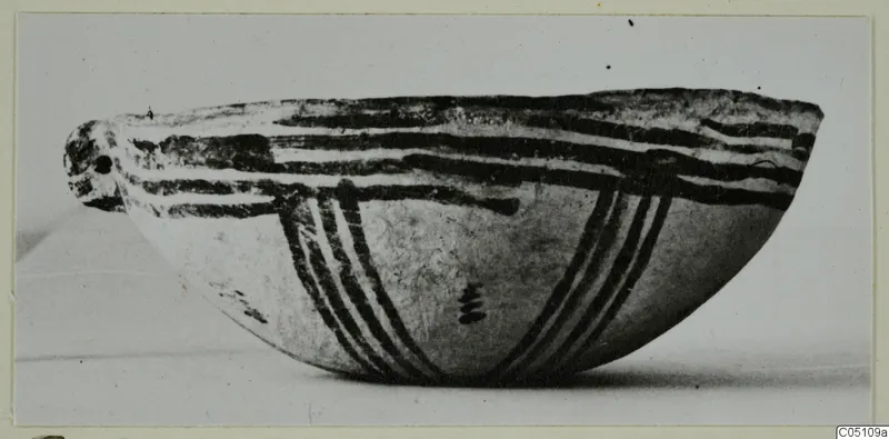 Side view of a White Slip Ware bowl with dark painted bands and stripes on its outside