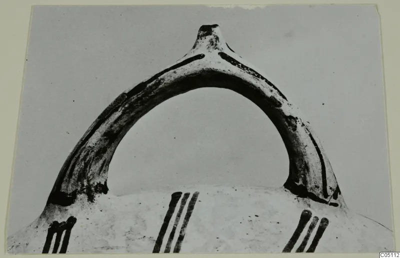 Handle of a White Slip Ware vessel with painted vertical strokes on the body below, from Enkomi