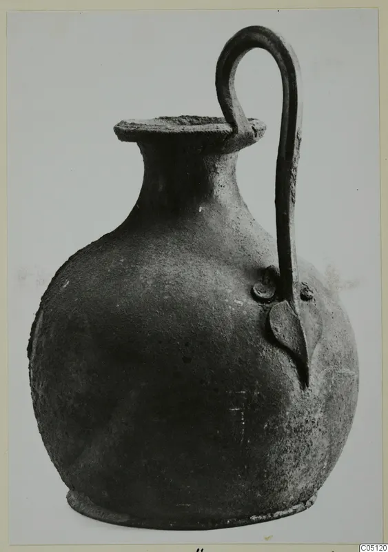 Round-bodied jug with a tall looped handle and a flat rim, photographed against a plain background.