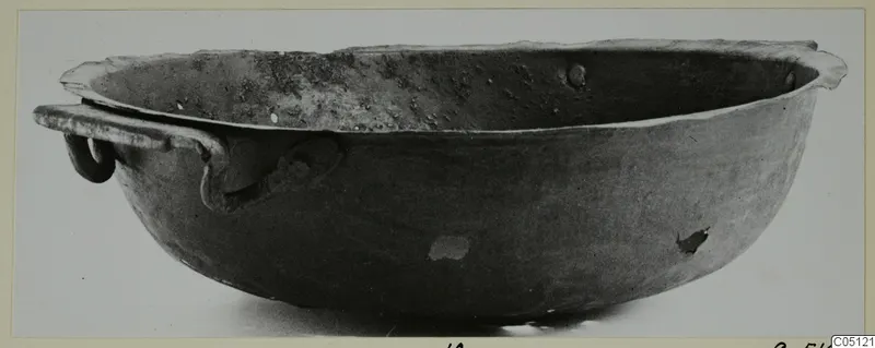 Bowl with a handle from Marion, seen from the side against a pale background.