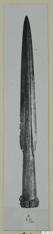 Metal sword blade from Amathus, photographed upright against a plain background on a card mount.