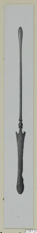 Bronze toilet implement from Amathus: a long slender shaft with a flattened, notched spatula end