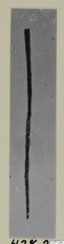 Long thin bronze pin or wire photographed on a grey card, from the Kastros tombs at Lapithos