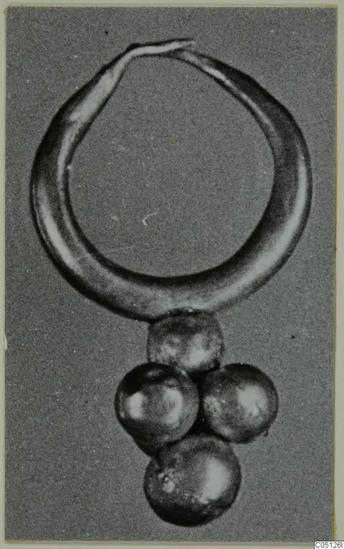 Gold hoop earring with a cluster of four round pendants, from Lapithos