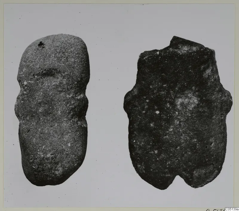 Two stone idols from Petra tou Limniti, photographed against a pale background.
