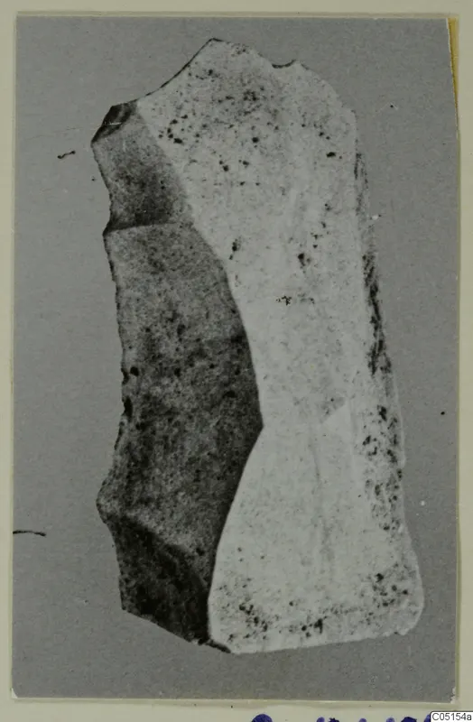 Stone chisel from Petra tou Limniti, a flat elongated stone object with broken edges