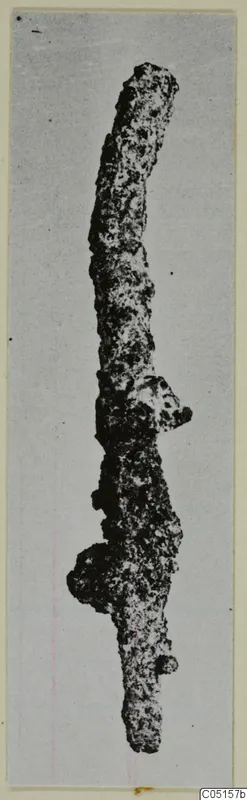 Corroded iron pin from Lapithos, Kastros tombs, shown upright against a pale background